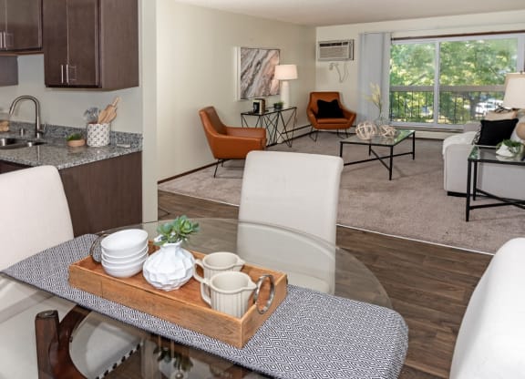 a living room and dining room with a glass table