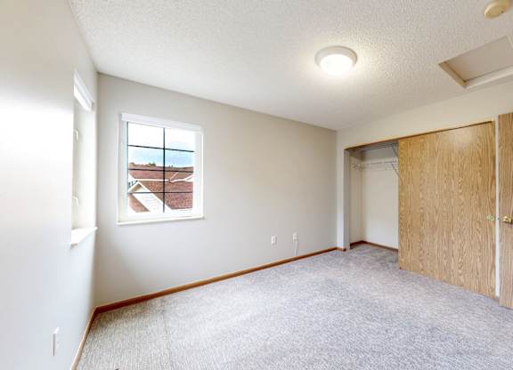 A room with a window and a door.