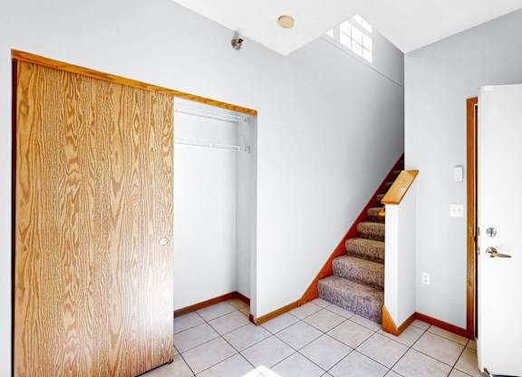 A room with a staircase and two doors.