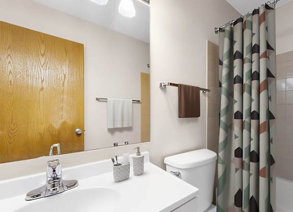 A bathroom with a white sink and a white toilet.