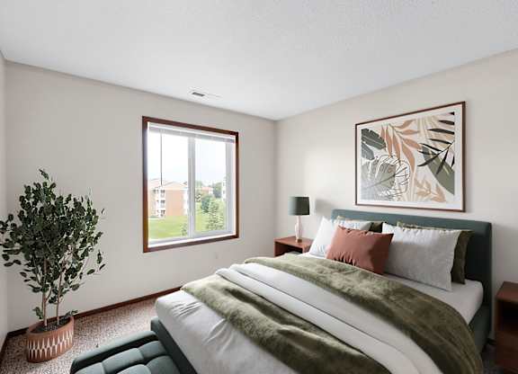 A bedroom with a bed, two lamps, a potted plant, and a framed picture on the wall.