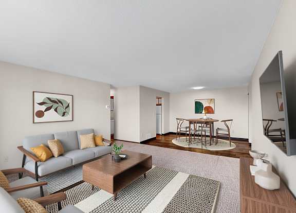 A living room with a grey sofa, a coffee table, and a television.