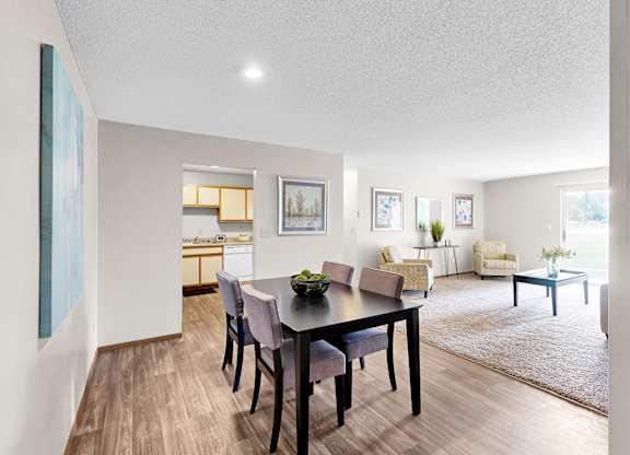 A dining room with a table and chairs is shown.
