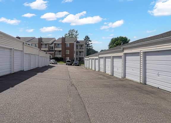 A long row of white garage doors are closed.