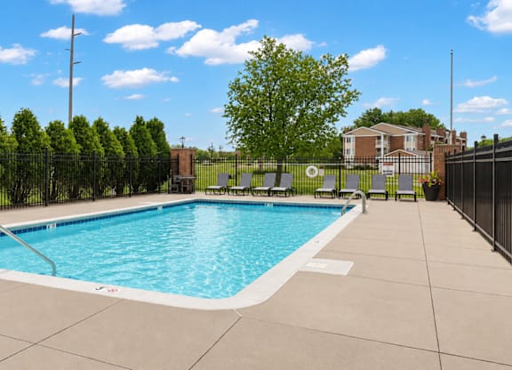 A small pool surrounded by a black fence.