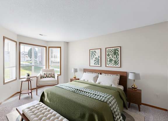 A bedroom with a bed, nightstand, and window.