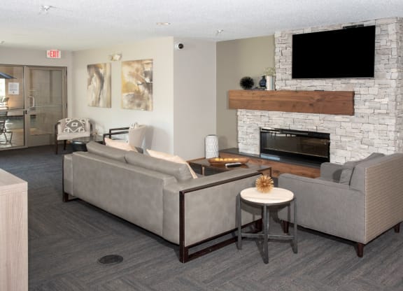 community room with seating, tv and fireplace