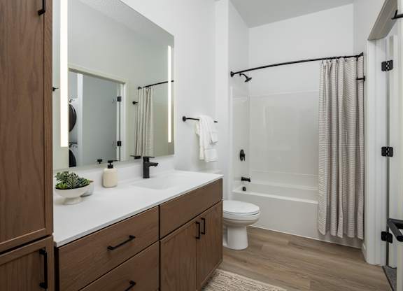 A bathroom with a white sink and a white toilet.