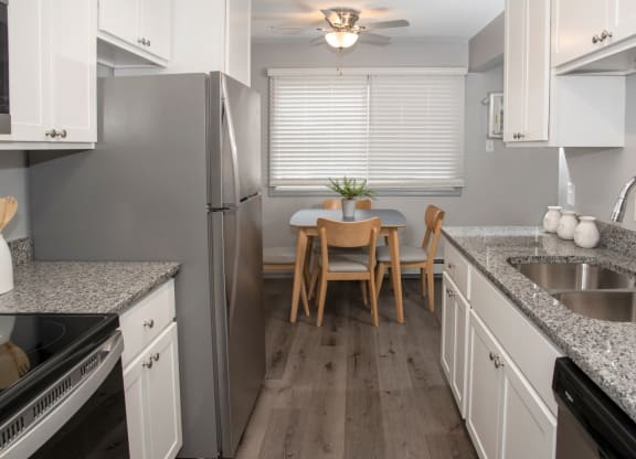 galley style kitchen with new finishes and dining area
