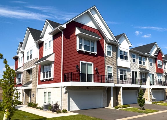 a row of town houses with red and white exterior