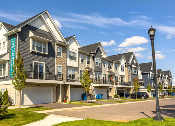 a row of town houses with balconies and street lights