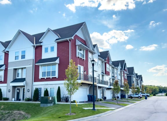 a row of red and white houses on a street