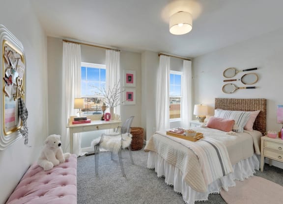 a bedroom with a bed and a desk and a window