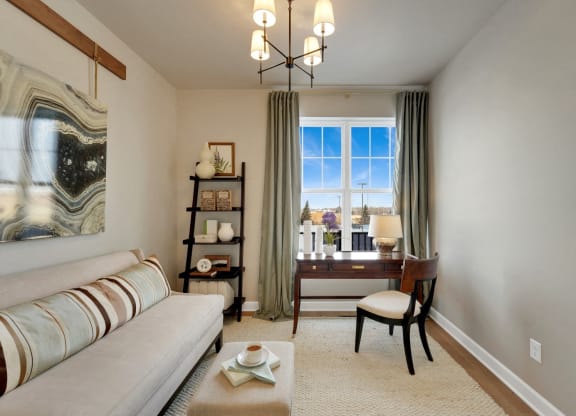 a living room with a white couch and a window