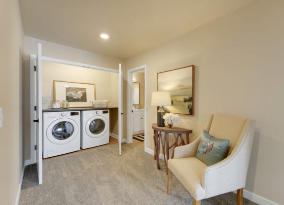 a living room with a washing machine and a dryer in it