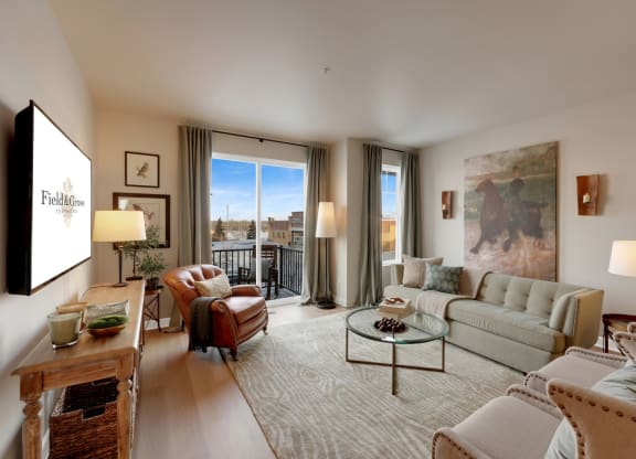 a living room filled with furniture and a large window