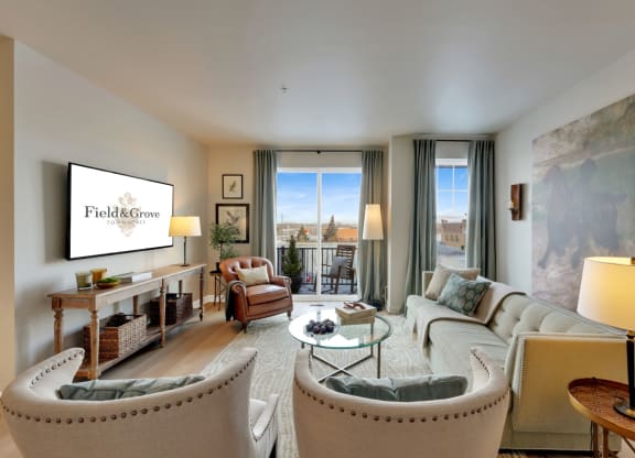 a living room with a couch and chairs and a tv