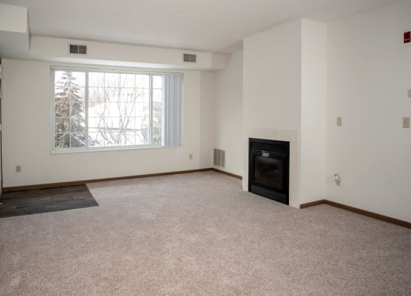 Living room with fireplace in select homes