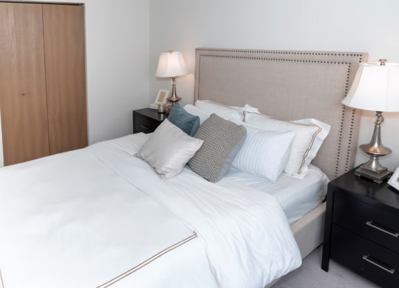 a bedroom with a bed and two nightstands