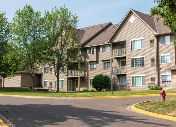 a large apartment building with a fire hydrant in front of it