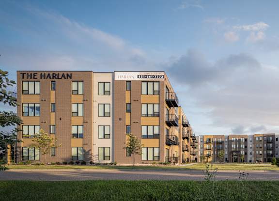 The Harlan apartment complex is a multi-story building with a modern design.