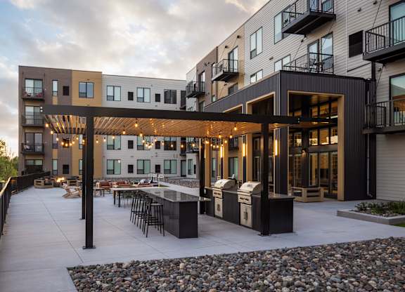 A modern building with a patio and a fire pit.
