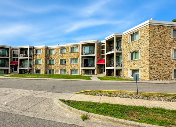 A large building with a lot of windows and a red awning.