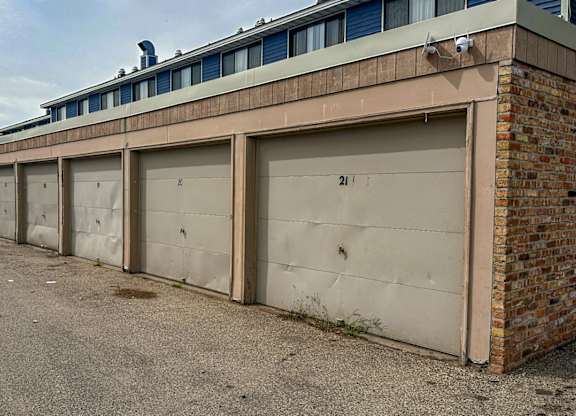 A long row of garage doors are closed.