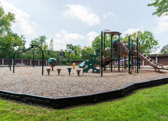 a playground with a climbing structure and picnic tables