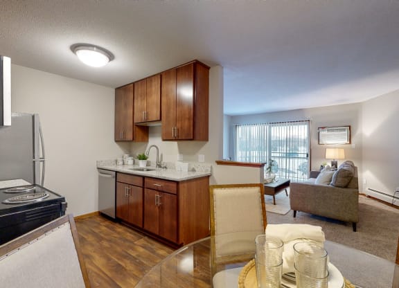 a kitchen and living room with a view of the balcony