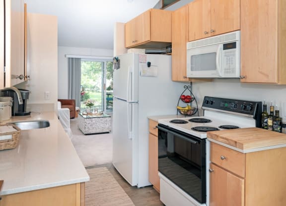 a kitchen with wooden cabinets and white appliances