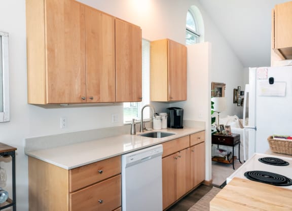 a kitchen with wooden cabinets and white appliances