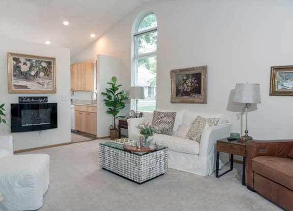 a living room filled with furniture and a large window
