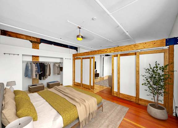 A bedroom with a bed and a potted plant.