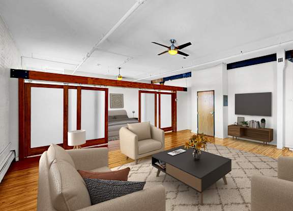A living room with a brown sofa, a grey armchair, a coffee table, and a television.