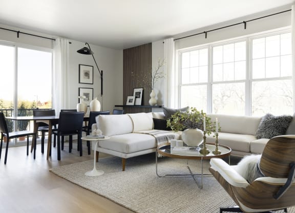 a living room with a white couch and a dining room table