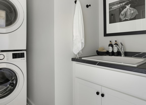 a small laundry room with a washing machine and a sink