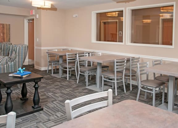 Multiple Small Tables with Chairs for Dining in Community Room in Carver, MN Apartments