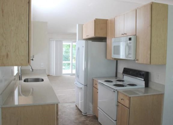 a kitchen with a white stove top oven next to a refrigerator