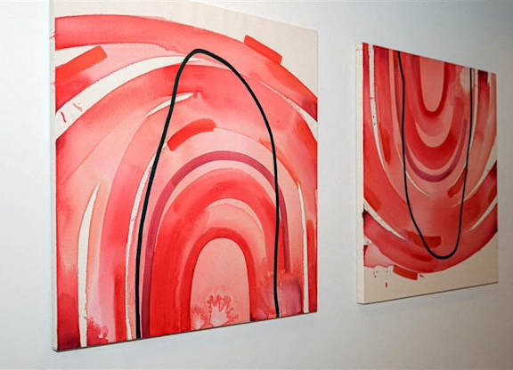 Two red abstract paintings on a white wall at The Bessemer at Seward Commons Apartments, Minneapolis, Minnesota
