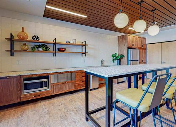A kitchen with a table and chairs at The Bessemer at Seward Commons Apartments, Minnesota, 55404