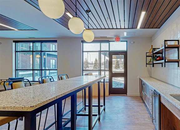 A kitchen with a long counter and a sink.