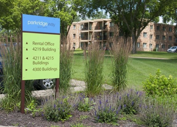 a sign in front of an apartment building
