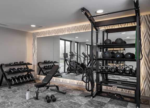 A well-equipped home gym with a variety of exercise equipment.