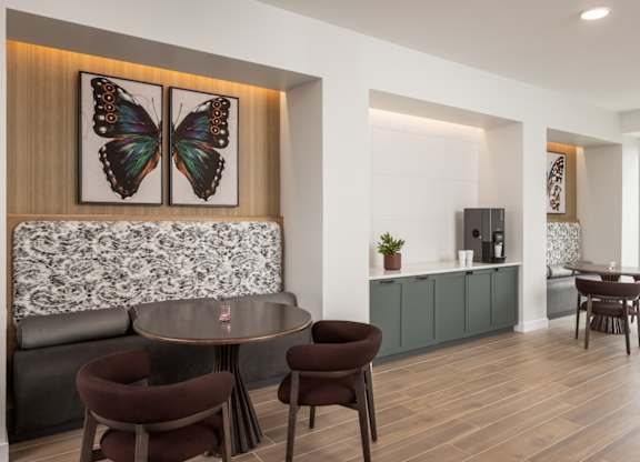 A modern dining room with a round table and chairs.