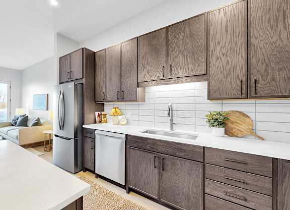 A kitchen with wooden cabinets and a white countertop.