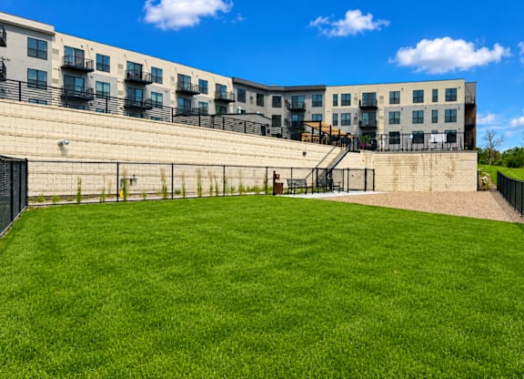 A grassy area in front of apartment buildings.