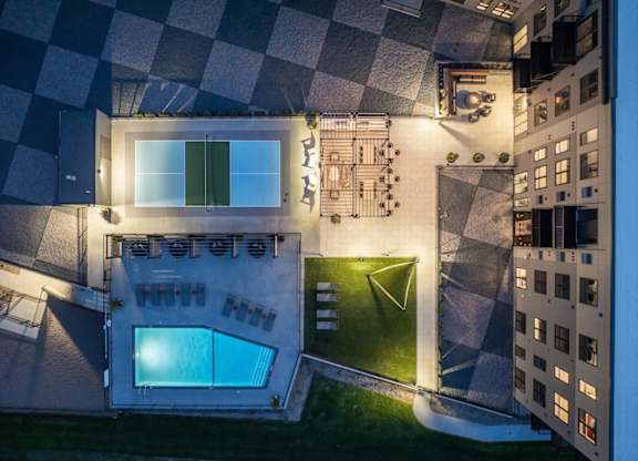 A modern house with a glass wall and a pool.