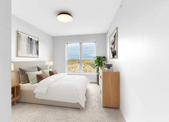 A bedroom with a large bed, a window with a view, and a wooden nightstand.