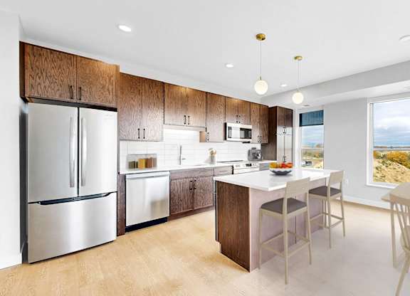 A modern kitchen with a dining table and chairs.